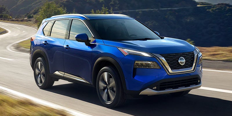 Blue 2021 Nissan Rogue running on road