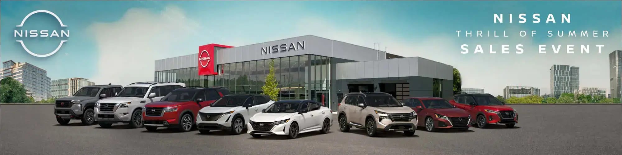 Exterior view of a Nissan dealership with several Nissan vehicles parked in front