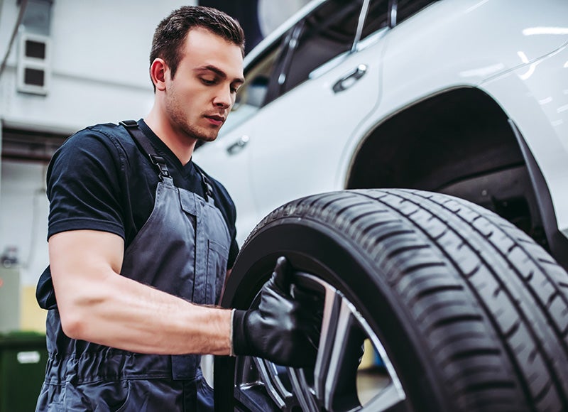 Mechanic checking a car tire